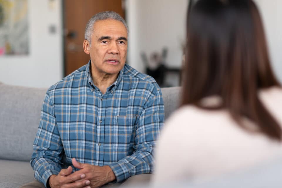 Older man getting talking to a therapist.